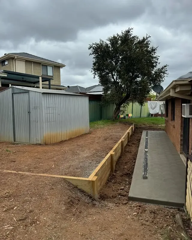 Timber retaining wall beside concrete and drainage works in Campbelltown